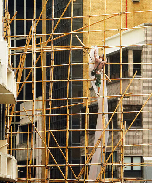 romain jacquet-lagrèze captures bamboo scaffolding workers hovering above hong kong