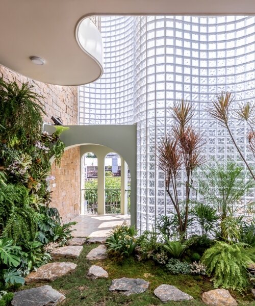curved facade of 3,000 glass bricks wraps DA VÀNG studio's translucent house in vietnam