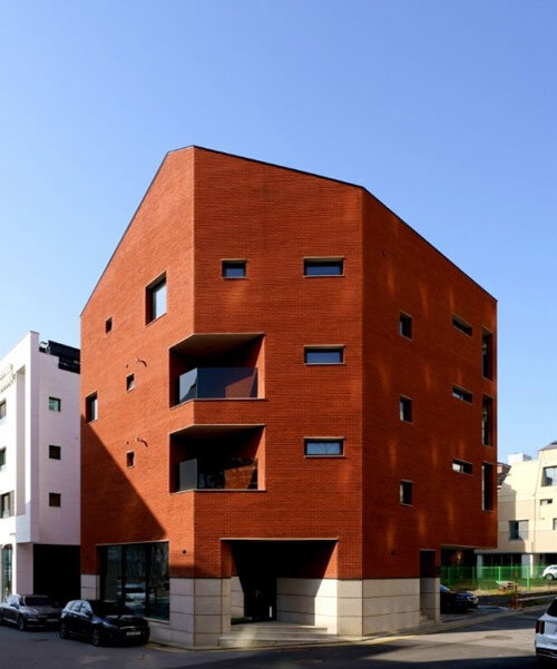 uniform red brick facade wraps cornerstone housing unit by LKSA in korea